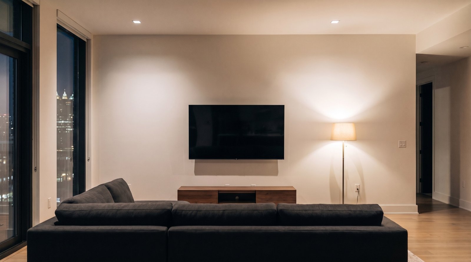 Living room before: a plain painted wall with a television and console