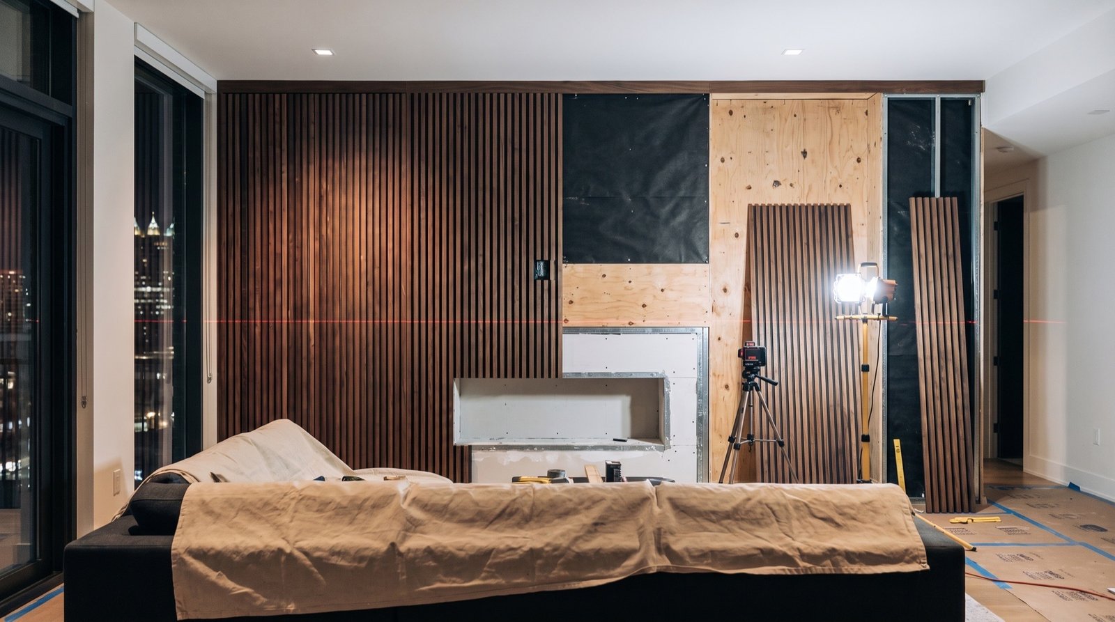 Slat panels being fitted around the fireplace opening during installation