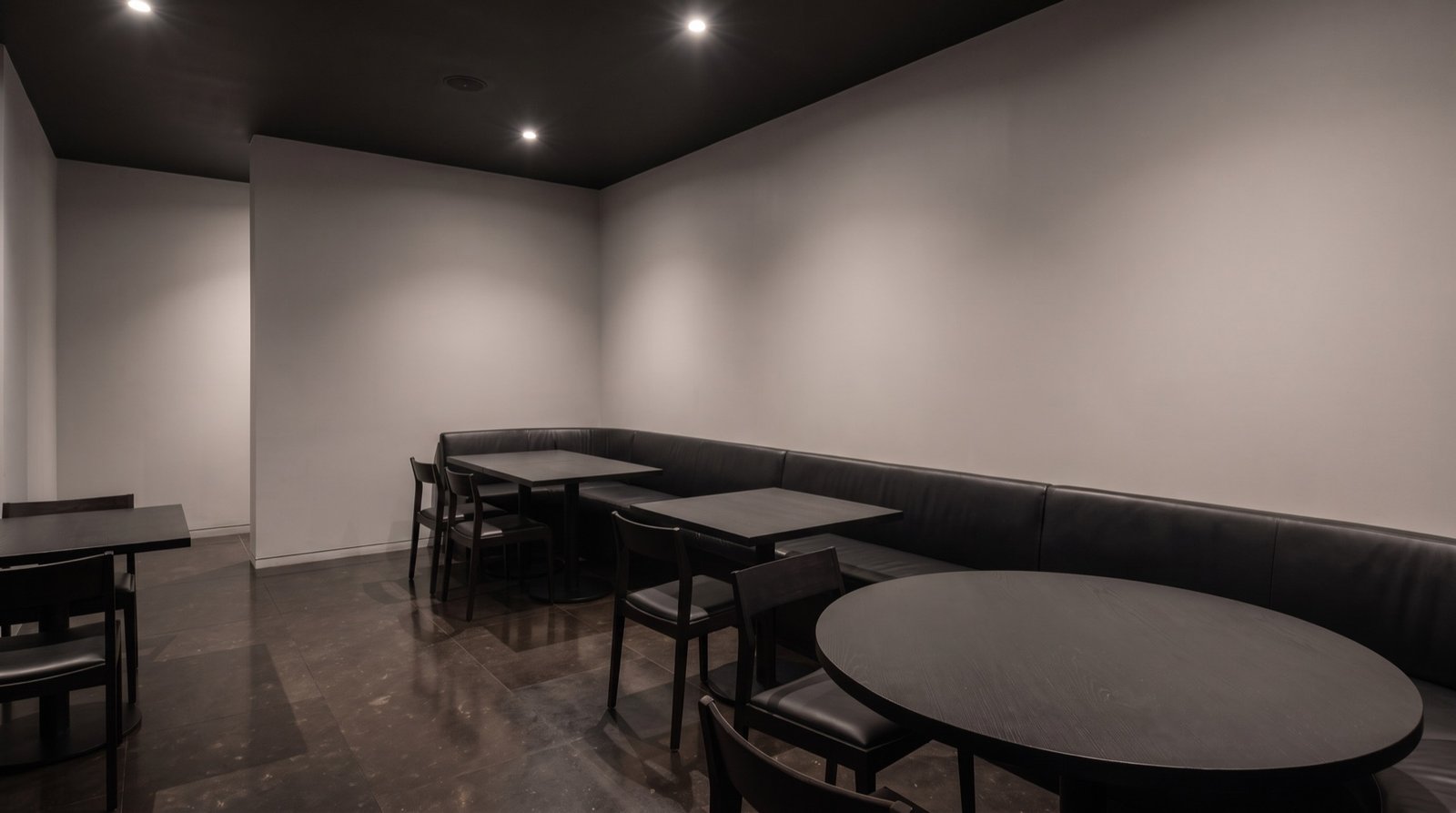 Dining room before: flat grey drywall and even ceiling lighting